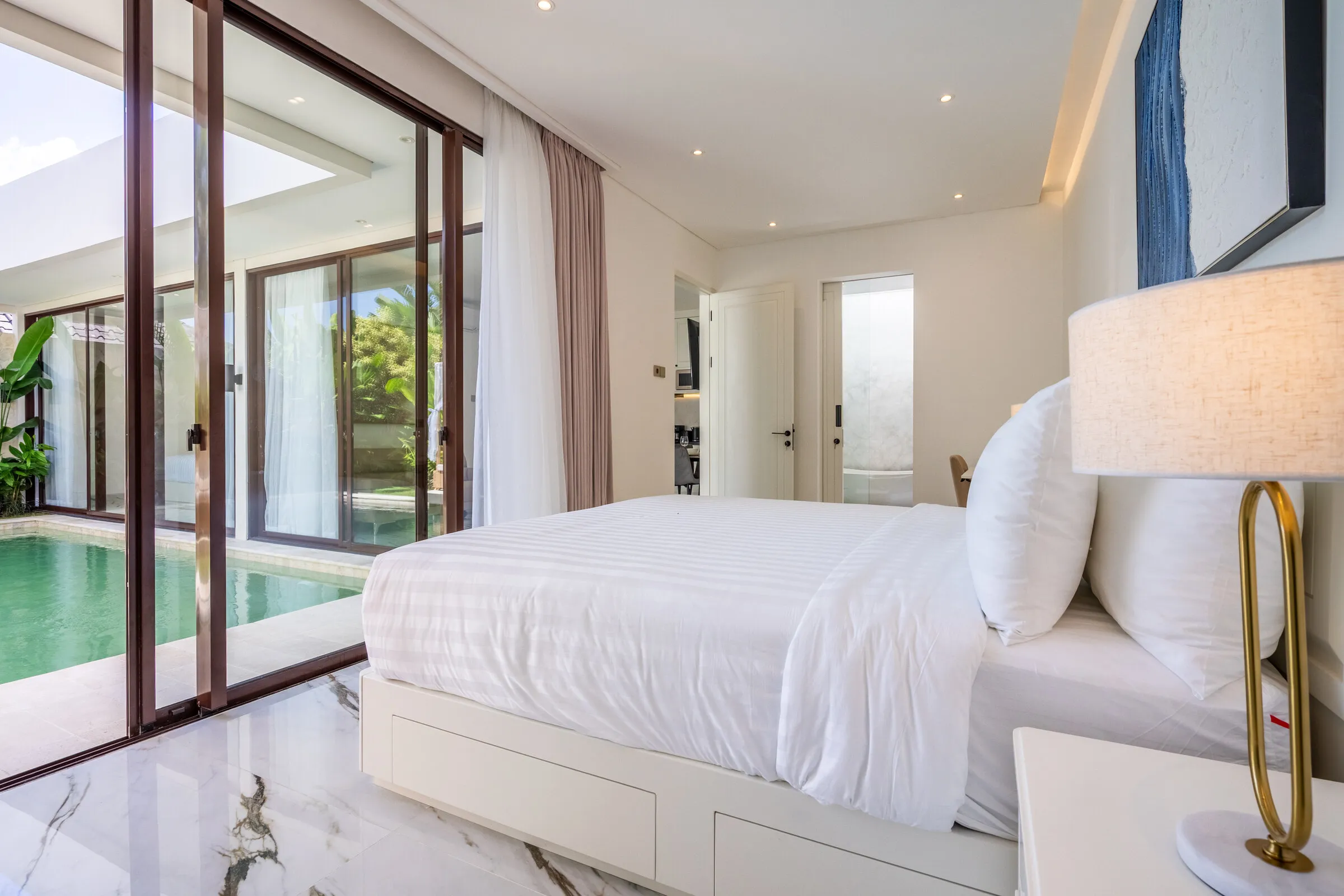 Master bedroom with glass doors opening onto the pool
