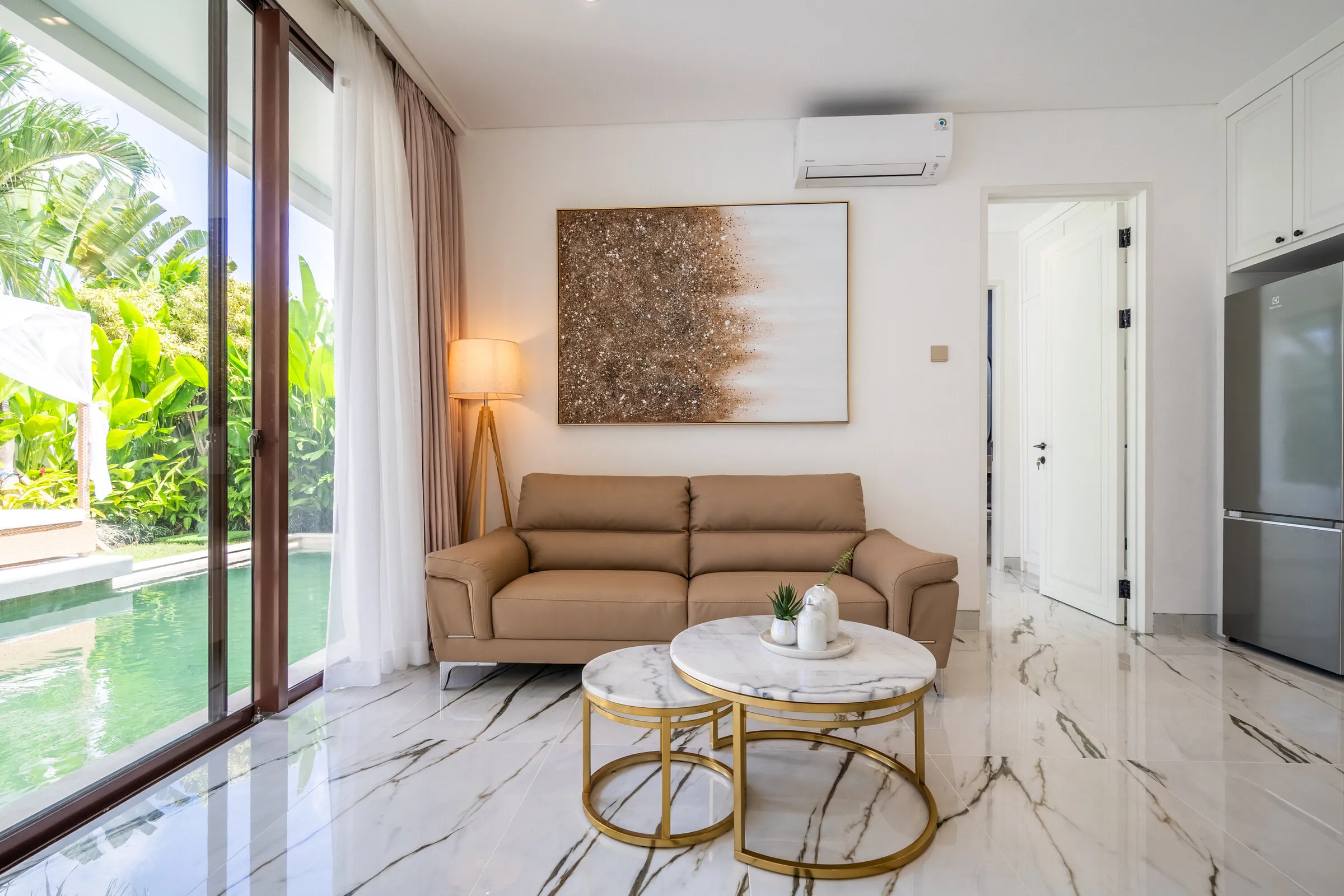 Open-plan living room with sofa and garden views