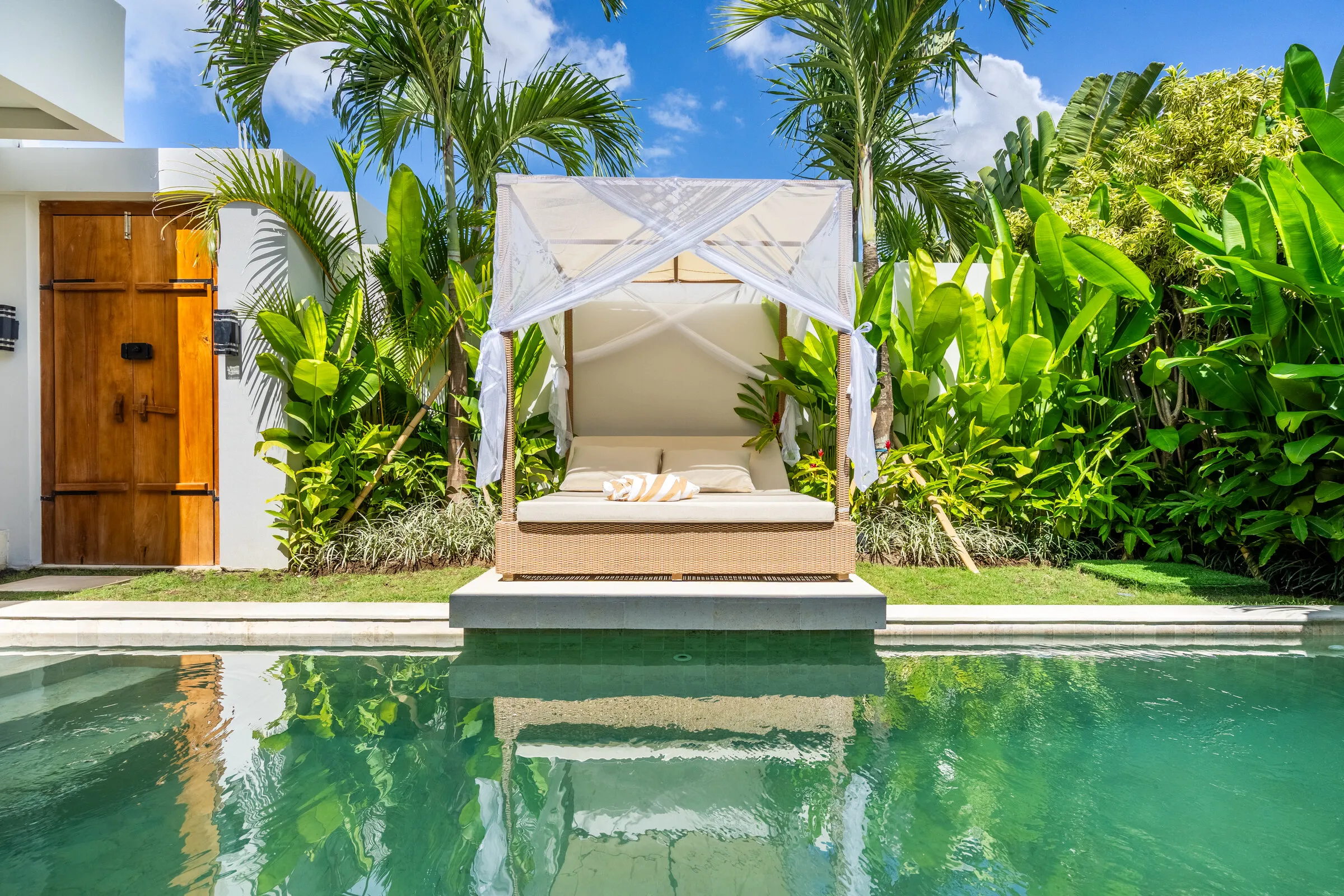 Private pool and canopied daybed in the garden of a Frelin two-bedroom villa